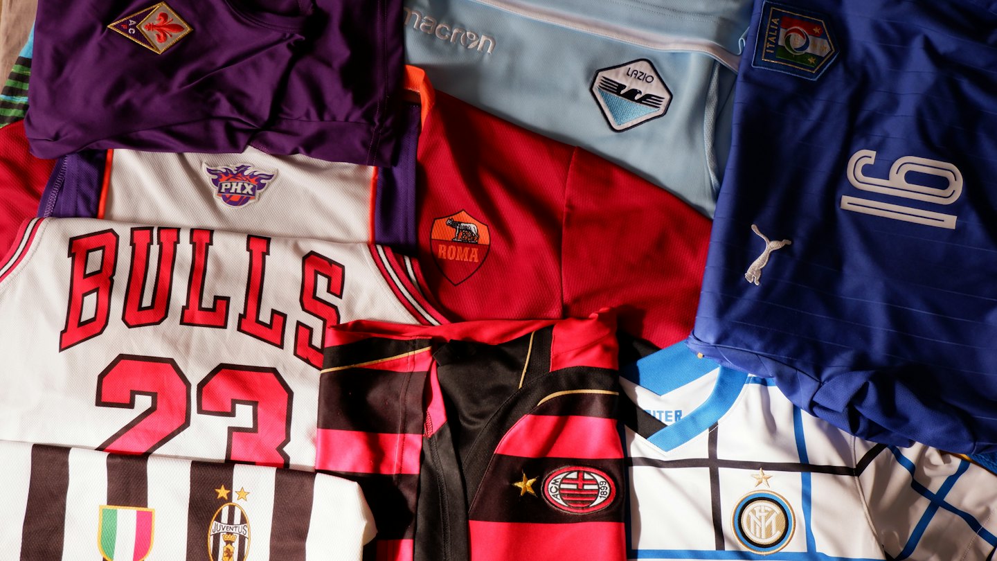 Assorted sports jerseys laid out on a flat surface.