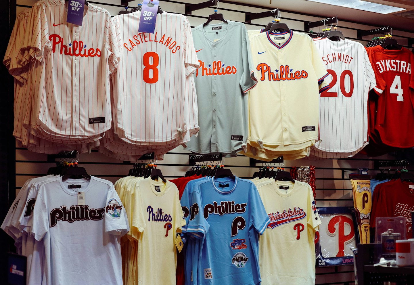 Philadelphia Phillies jerseys and apparel displayed on a store rack.